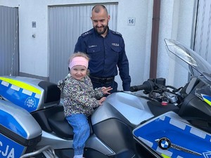 na policyjnym motocyklu siedzi dziewczynka