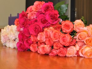 na stole leżą róże w różnych odcieniach
