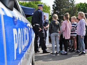 policjanci rozmawiają z grupą dzieci podczas festynu